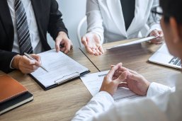 Employer or committee holding reading a resume with talking during about his profile of candidate, employer in suit is conducting a job interview, manager resource employment and recruitment concept Beratung
