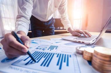 Businessman accountant or financial expert analyze business report graph and finance chart at corporate office. Concept of finance economy, banking business and stock market research. Businessman accountant or financial expert analyze business report graph and finance chart at corporate office. Concept of finance economy, banking business and stock market research.