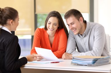 Saleswoman talking with customers at office