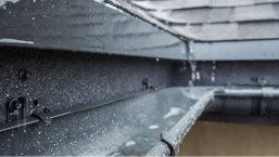 Jets of rain drain into the drainage system on the roof of the house Jets of rain drain into the drainage system on the roof of the house