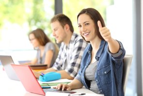 Proud student posing with thumbs up at classroom Proud student posing with thumbs up at classroom