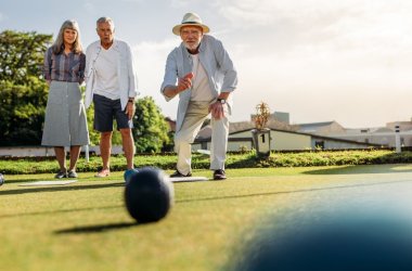 Group of senior people playing boules in a lawn