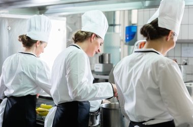 Female Chefs working in industrial kitchen