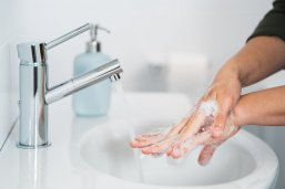 Hygiene. Cleaning Hands. Washing hands with soap. Young woman washing hands with soap over sink in bathroom, closeup. Covid 19. Coronavirus. Hygiene. Cleaning Hands. Washing hands with soap. Young woman washing hands with soap over sink in bathroom, closeup. Covid 19. Coronavirus.