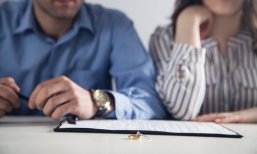 Couple with divorce contract and ring on desk. Divorce Couple with divorce contract and ring on desk. Divorce