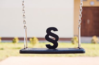 Black paragraph symbol on children chain swing.