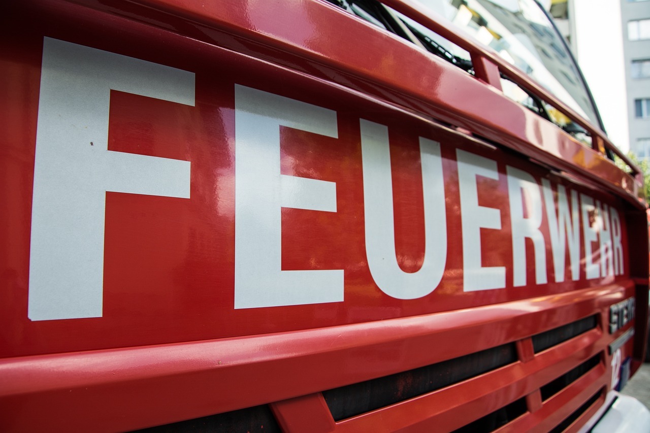 Eine Nahaufnahme des Schriftzugs "Feuerwehr" auf einem großen Feuerwehrauto