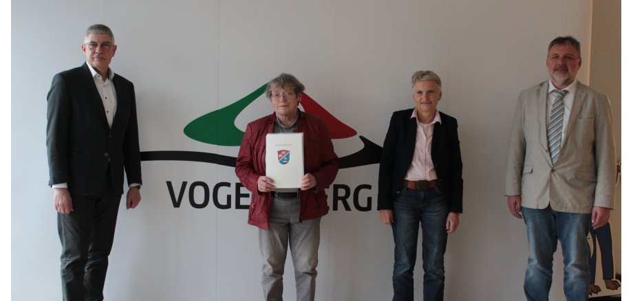 Landrat Manfred Görig, Amtsleiterin Dr. Maria Dolderer-Litmeyer und Verwaltungsleiter Bernd Sterz (von links) verabschieden Dr. Elsbeth Hof (Zweite von links) in den Ruhestand. Sie stehen vor einer hellen Wand und schauen in die Kamera