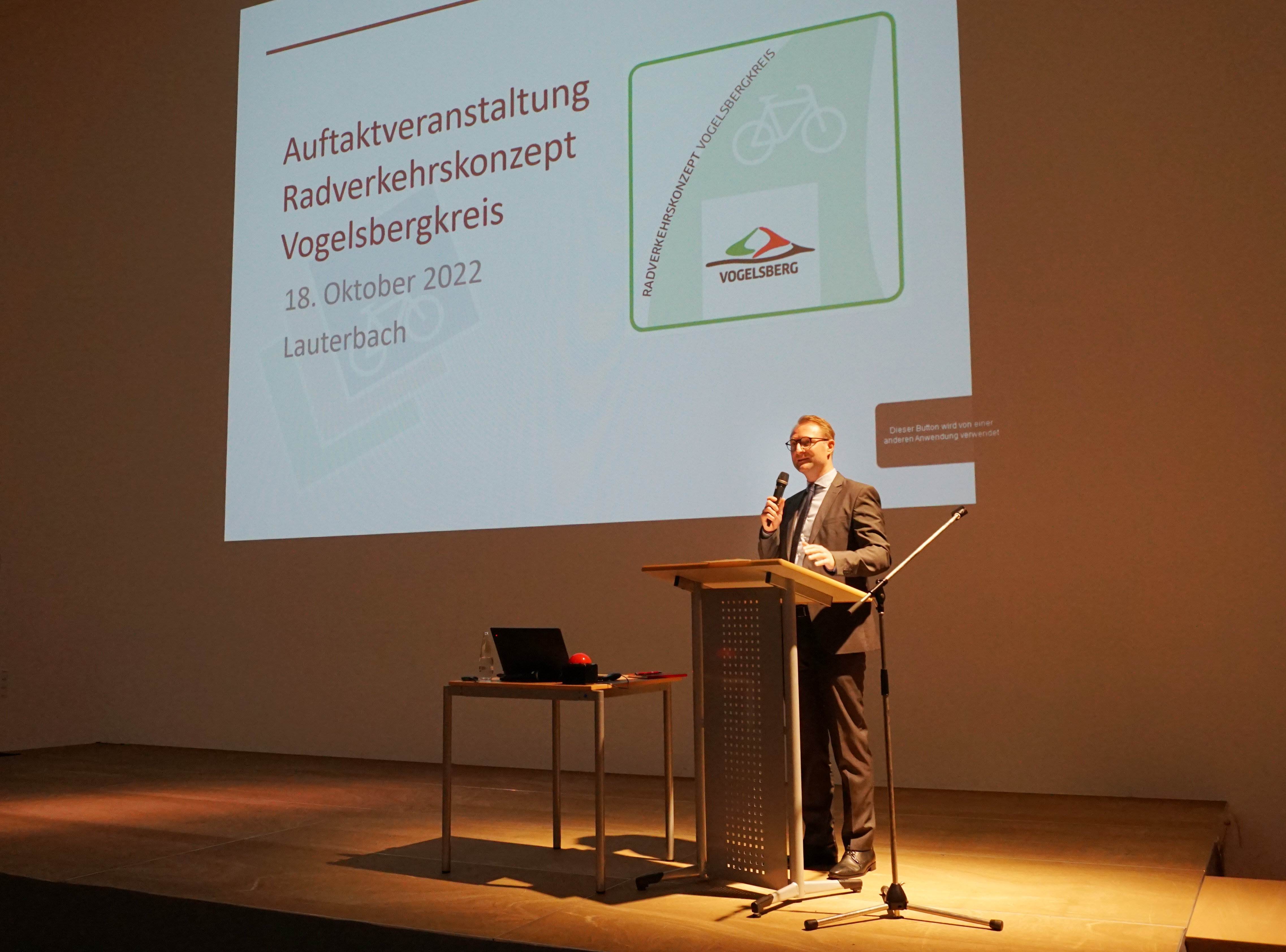 Dr. Jens Mischak auf der Bühne. Er präsentiert die Überlegungen zum Radverkehrskonzept
