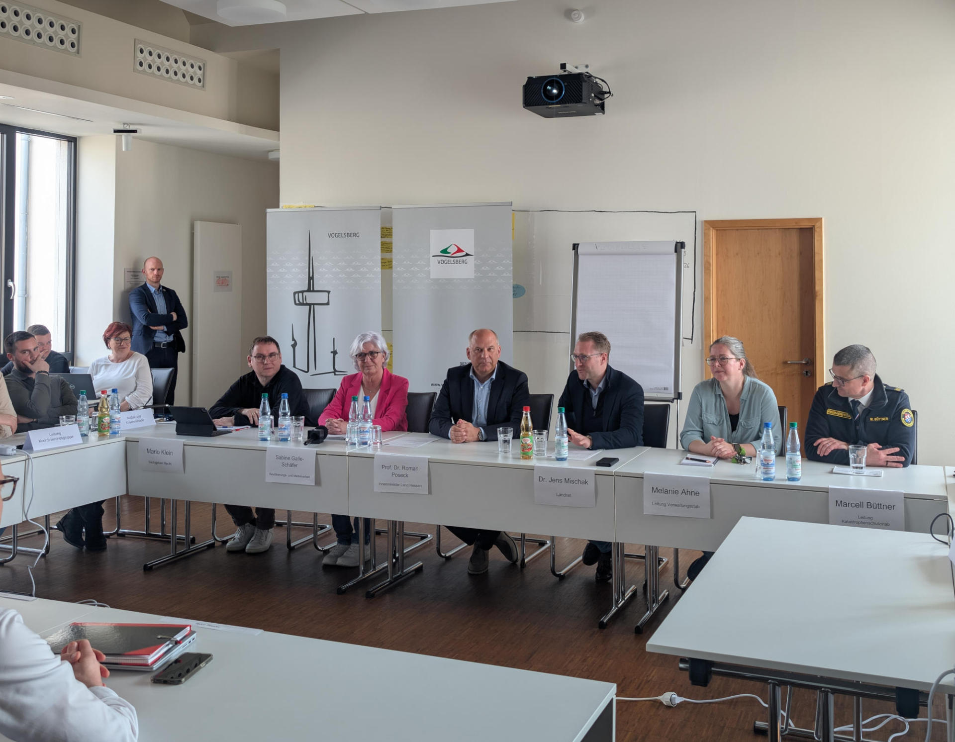 Realitätsnaher kann eine Übung kaum sein: Hessens Innenminister Prof. Roman Poseck und Landrat Dr. Jens Mischak (Mitte) stellen sich gemeinsam mit Kreisbrandinspektor Marcell Büttner, Melanie Ahne, Leitung Verwaltungsstab, Pressesprecherin Sabine Galle-Schäfer und Jurist Marion Klein aus dem Sachgebiet Recht (von rechts) in einer kurzfristig anberaumten Pressekonferenz den Fragen der „Journalisten“.